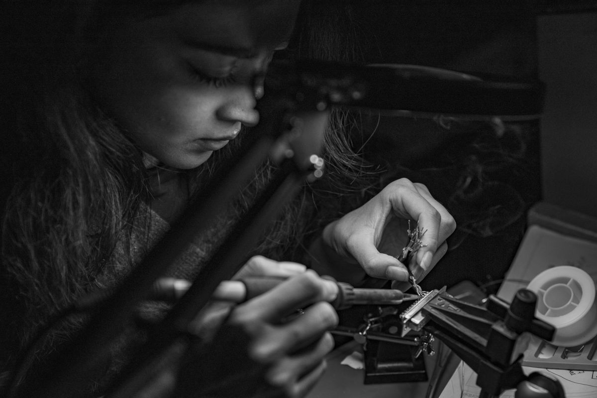 Belle Garcia, recording engineer, soldering an audio cable connector in the studio